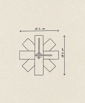 Hand-drawn diagram of the Normann Copenhagen Watch Me Wall Clock—a modern minimalist decor piece. Rectangular shapes radiate from the center, with width and height of 28.15 cm and clock hands pointing to 12:15. Brand: Normann Copenhagen.