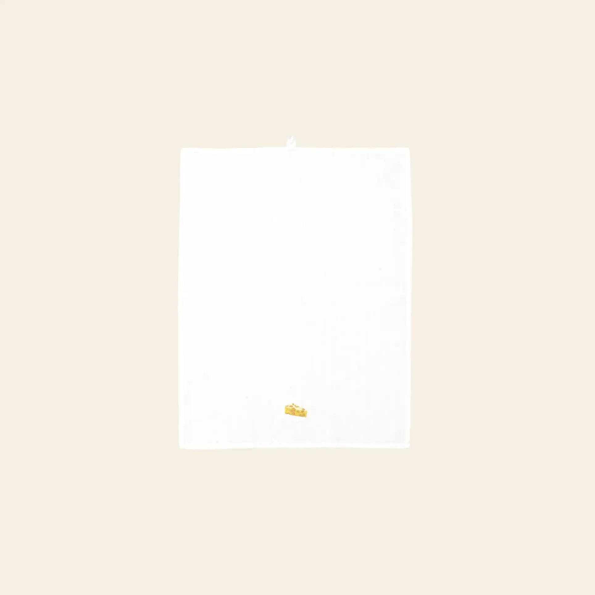 The Normann Copenhagen Yummy Tea Towel by Normann Copenhagen, made from linen and cotton, is shown on a light beige background with a small embroidered yellow wedge of cheese near the bottom edge.