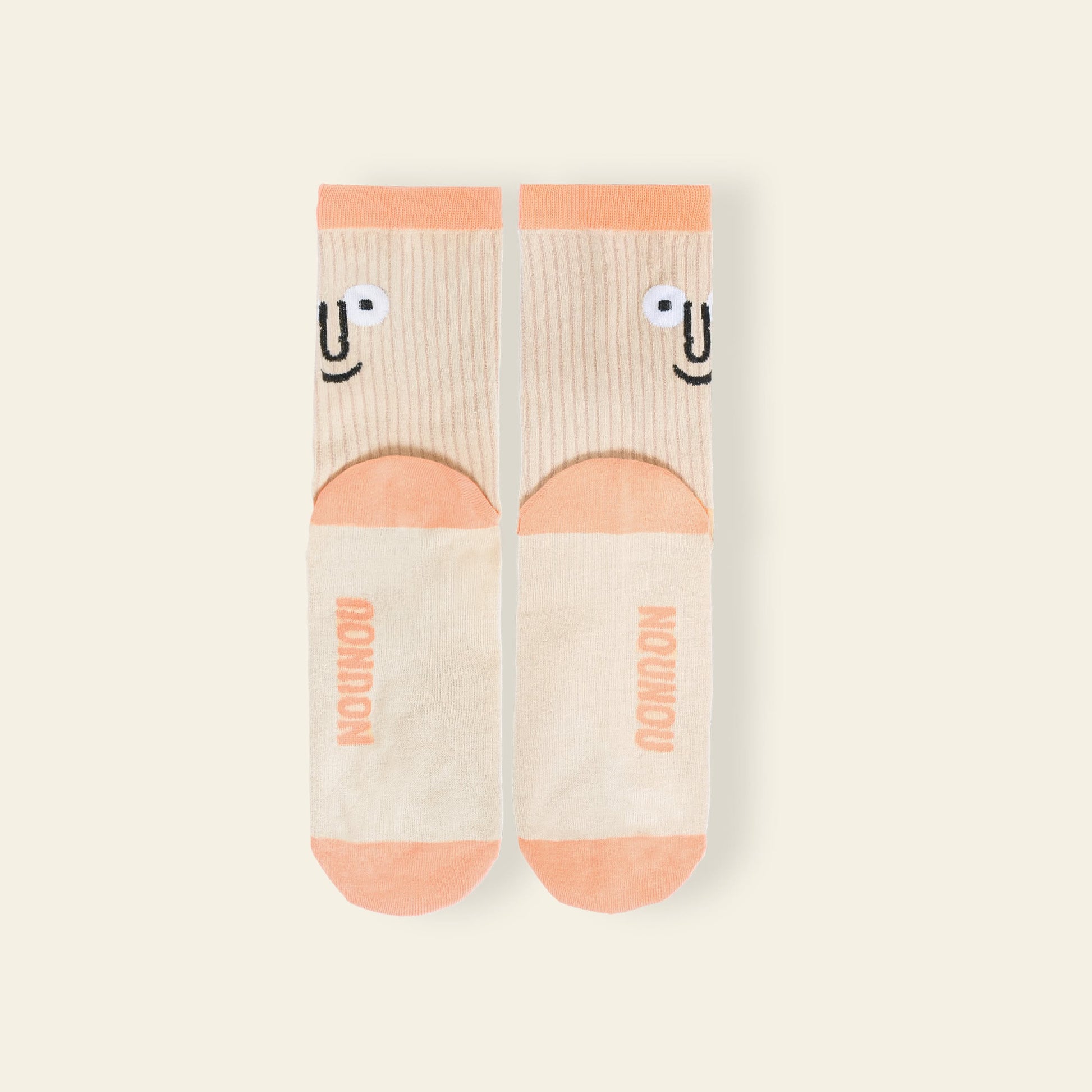 The NouNou Face Socks Set - Coral/Blue by NouNou features playful smiling faces and brand logo on the soles, making them a fun and colorful addition to your socks collection.