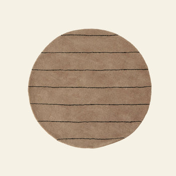 The OYOY Living Design Striped Circle Rug by OYOY Living Design is a round wool and cotton rug with thin, evenly spaced black horizontal stripes on a beige base—ideal for complementing any home decor.