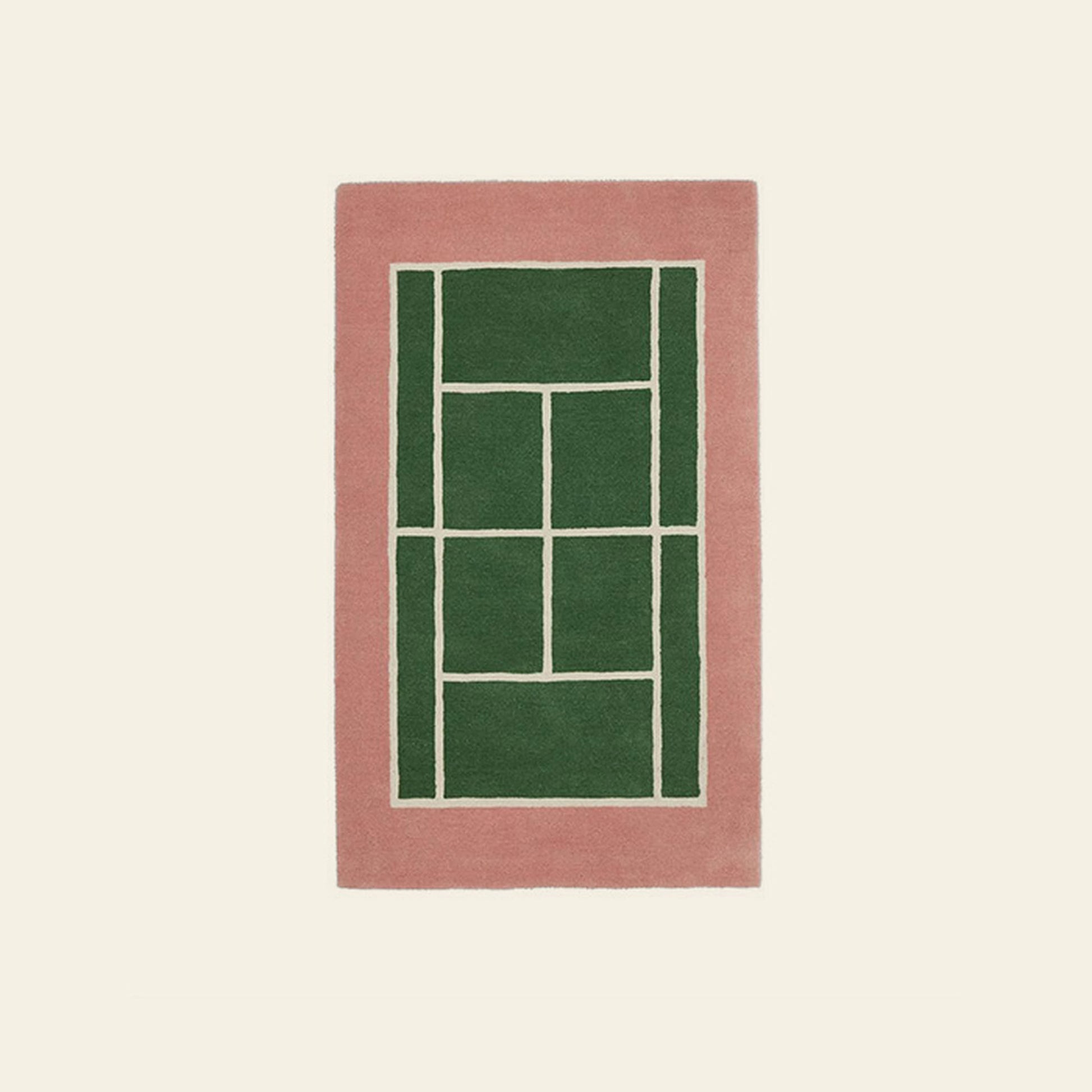The OYOY Living Design Tennis Rug, crafted from a wool-cotton blend, features a thick pink border and geometric green center with white dividing lines, adding sporty flair to any plain off-white space.