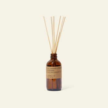 The P.F. Candle Co. 3.5oz Reed Diffuser in Teakwood & Tobacco features a brown glass bottle with kraft label and diffuser sticks—an elegant way to enjoy signature scents and quality fragrance oils in your space.