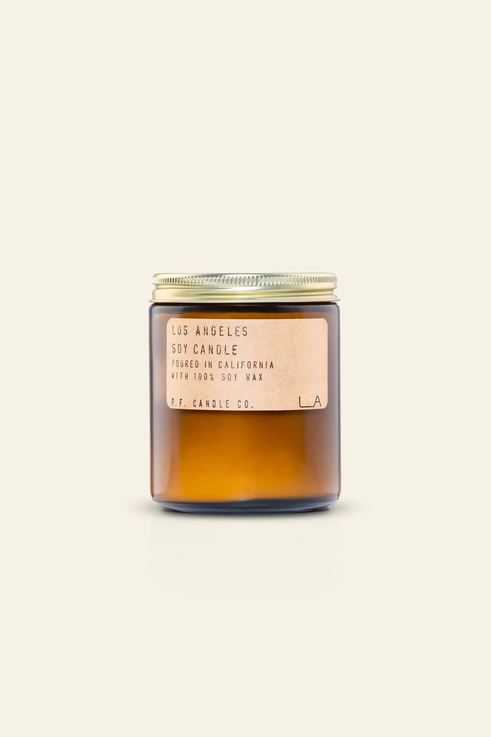 The P.F. Candle Co. Los Angeles Limited Edition 7.2 oz Soy Candle features a brown glass jar with a gold lid and beige label, set against a light cream background—ideal for indulging in California dreaming.