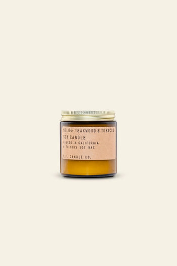 The P.F. Candle Co. No. 4 Teakwood & Tobacco 3.5 oz Mini Candle features a small amber glass jar with a beige label, set against a simple light background, and is made by P.F. Candle Co. in California.