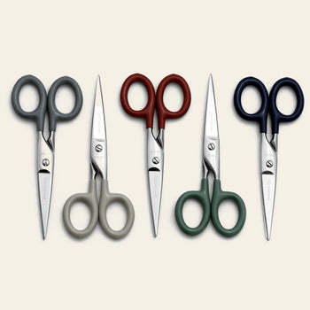 Four pairs of Penco Stainless Steel Scissors S, featuring handles in gray, beige, red, green, and navy blue, are neatly arranged side by side on a plain light background. Created by Penco, these stainless steel scissors offer everyday functionality paired with a stylish design.