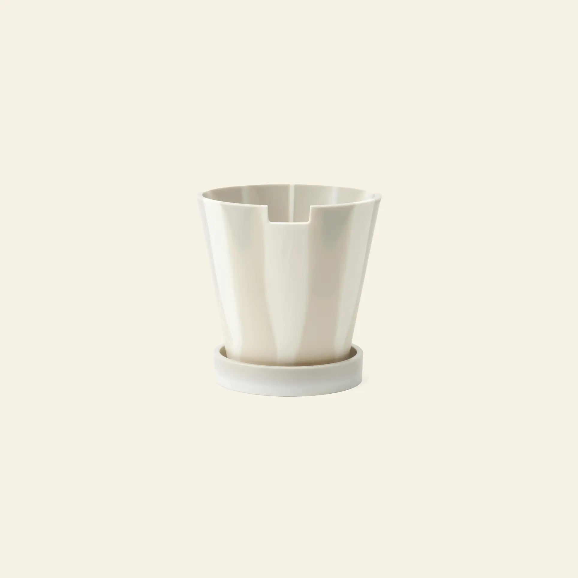 The Plastic Ark Dirty Pot by Plastic Ark is a modern white cylindrical recycled plastic pot with vertical grooves and a matching round base, shown against a plain cream background.