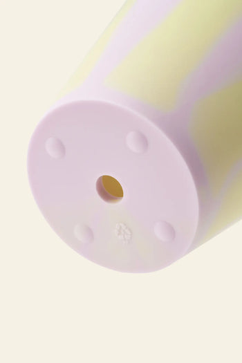 Close-up of the Plastic Ark Dirty Pot by Plastic Ark: a cylindrical pastel tumbler made from recycled plastic, featuring a light purple base with four small circular feet and a central hole, set against a neutral background.