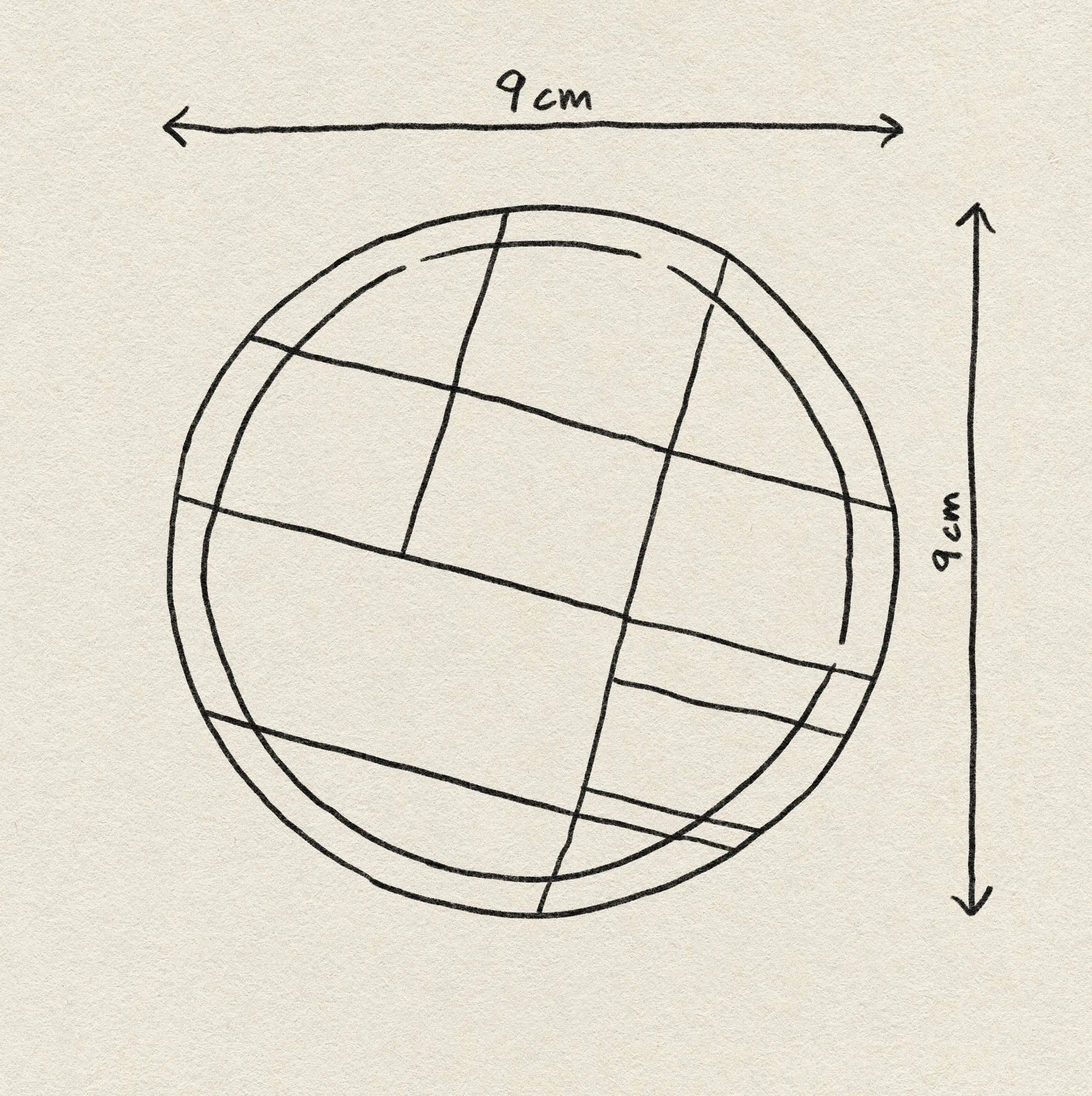 A hand-drawn circle with intersecting lines, measuring 9 cm in height and width as marked by arrows, is sketched on textured paper—perfect inspiration for Poketo’s Bamboo Coasters, Set of 4.