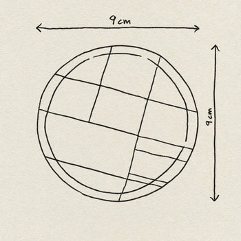 A hand-drawn circle with intersecting lines, measuring 9 cm in height and width as marked by arrows, is sketched on textured paper—perfect inspiration for Poketo’s Bamboo Coasters, Set of 4.