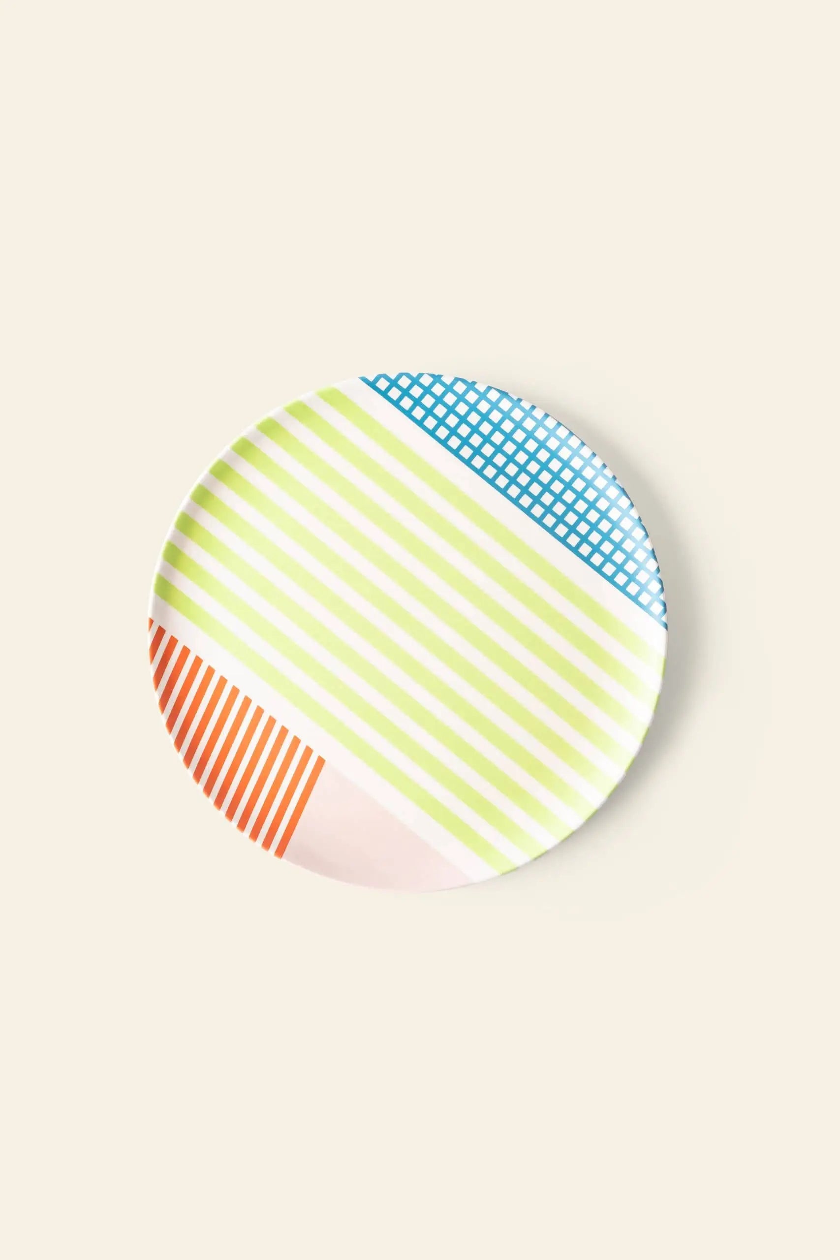 The Poketo Bamboo Salad Plate by Poketo features geometric patterns—blue grid, green diagonal stripes, and orange lines—on a light beige bamboo base for stylish, eco-friendly tableware.