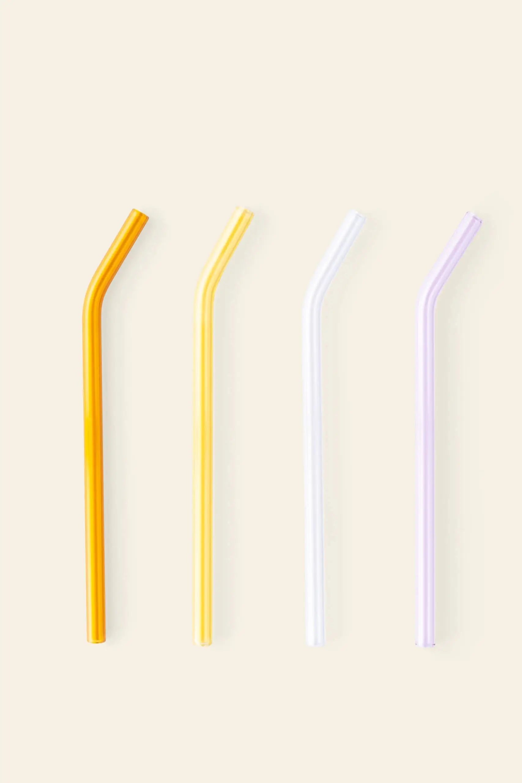Poketo Glass Straws, Set of 4 by Poketo: four eco-friendly bent glass straws—orange, yellow, clear, and light purple—lined up on a light background for sustainable sipping.