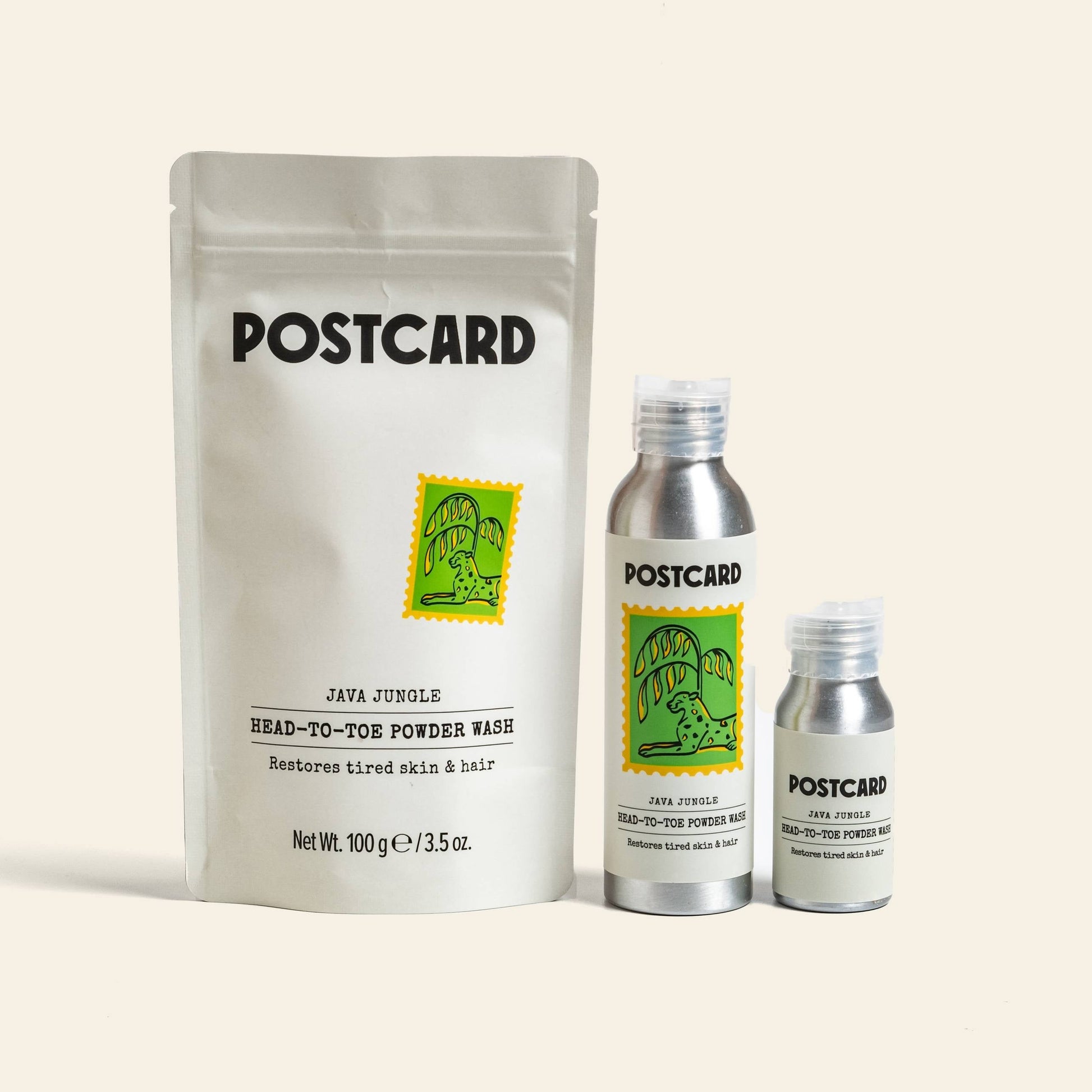 Three Postcard Head-To-Toe Powder Wash, 80g - Java Jungle products are shown: a pouch and two silver bottles. All feature a green postage stamp with a tiger and offer a sulfate-free powder-to-foam cleansing formula.