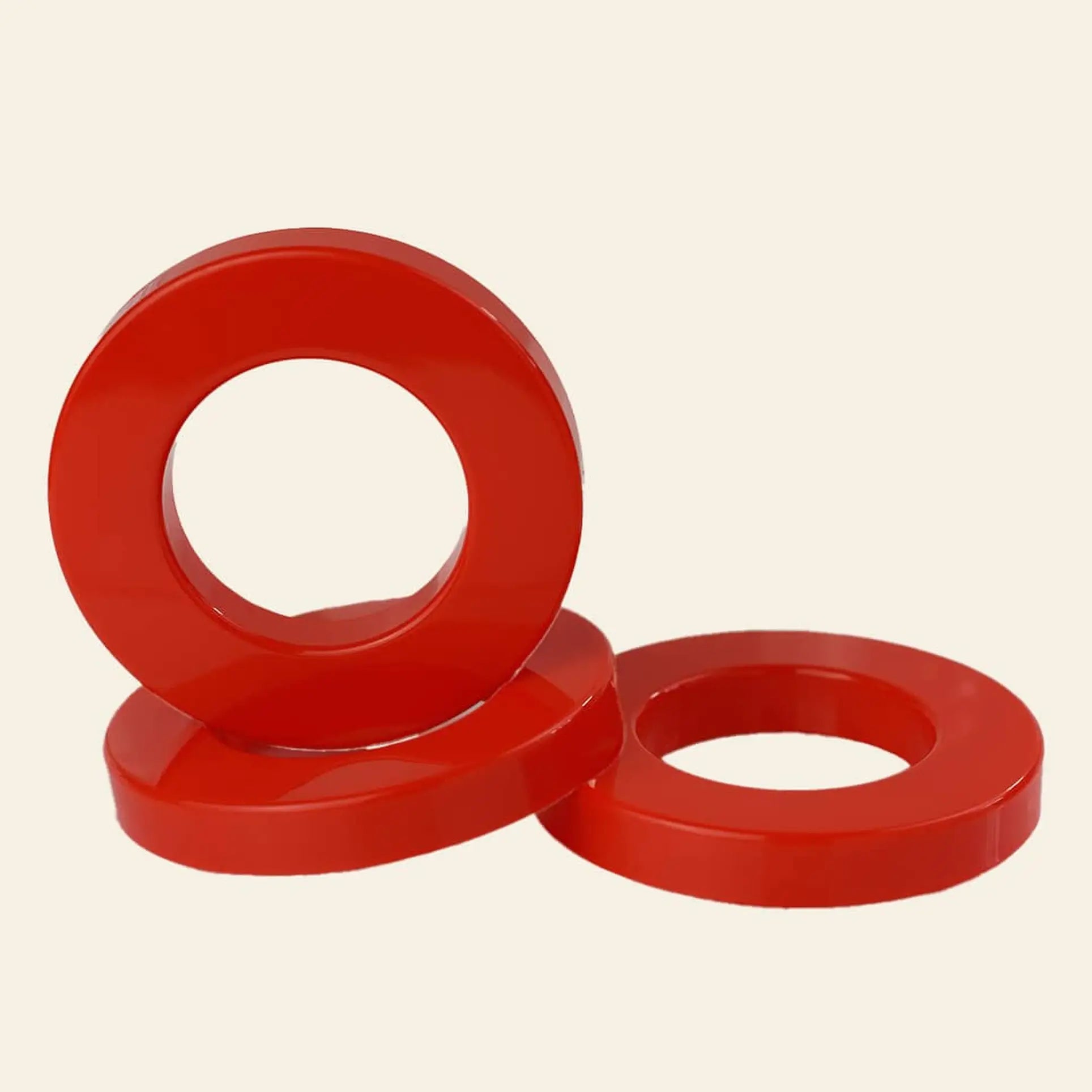 Three colorful Ring A Date Calendar Rings by Ring-A-Date are stacked together—one upright, two flat—on a plain light background, evoking the classic look of the original Ring-A-Date wall calendars.