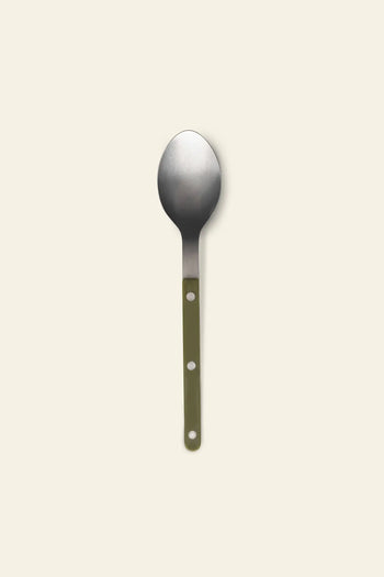 The Sabre Bistrot Vintage Soup Spoon by Sabre features a flat green handle with two circular holes, crafted from stainless steel and shown on a light beige background—capturing French cafe charm.