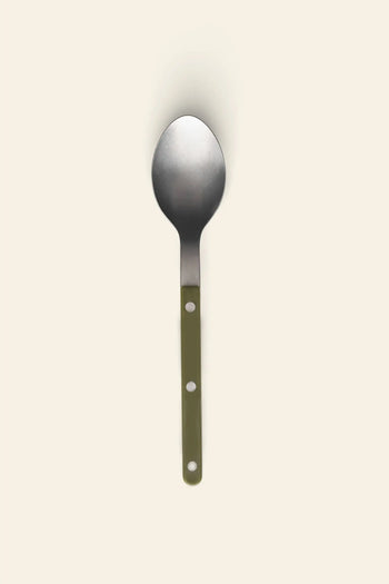 The Sabre Bistrot Vintage Soup Spoon by Sabre, featuring a green handle with two white rivets and stainless steel construction, is centered on a plain beige background.