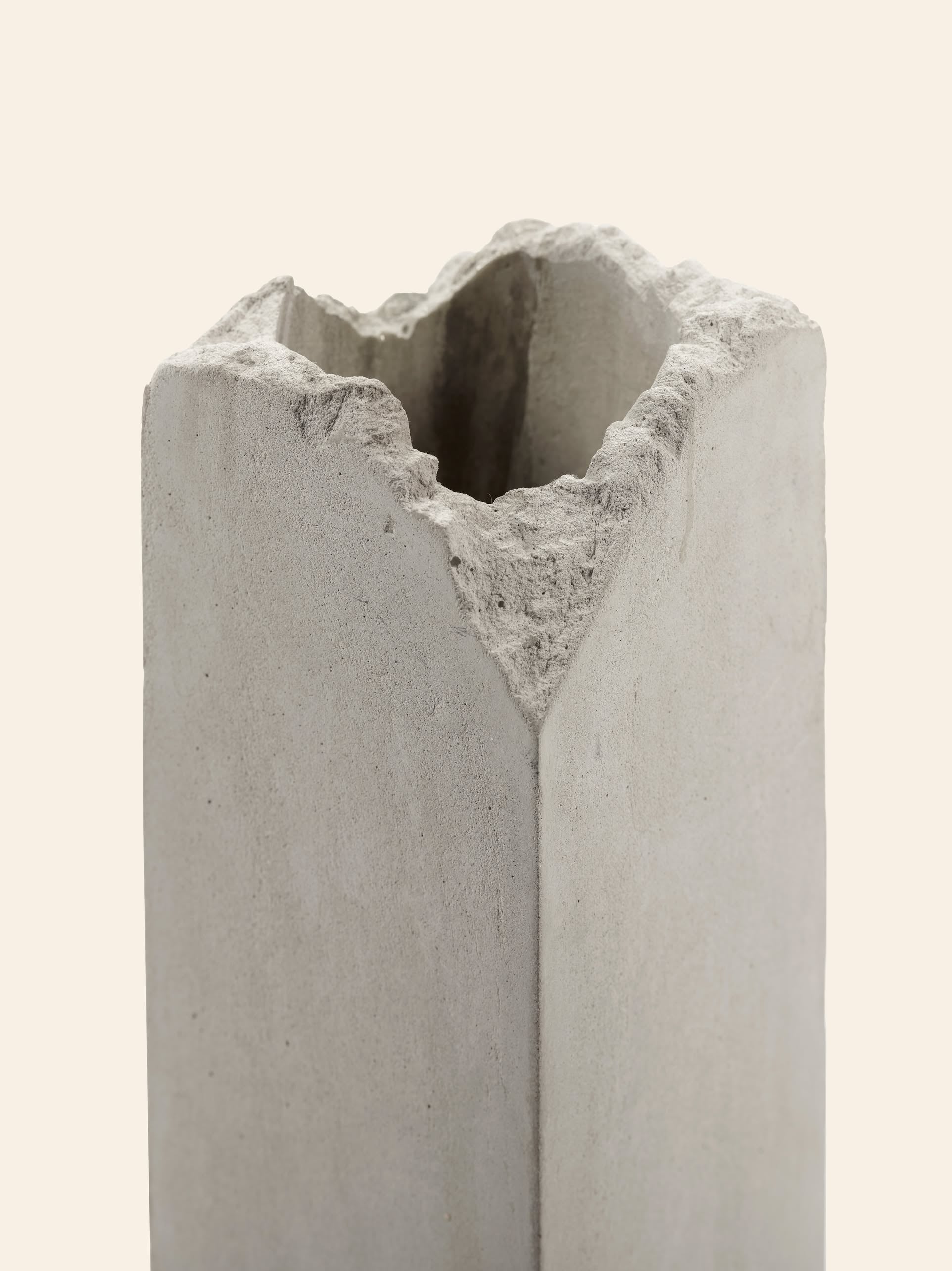 The Serax Broquaine Concrete Vase S - Grey by Serax is a tall, rectangular vase featuring rough, jagged edges at the top, creating a modern, unfinished look against a plain light background.