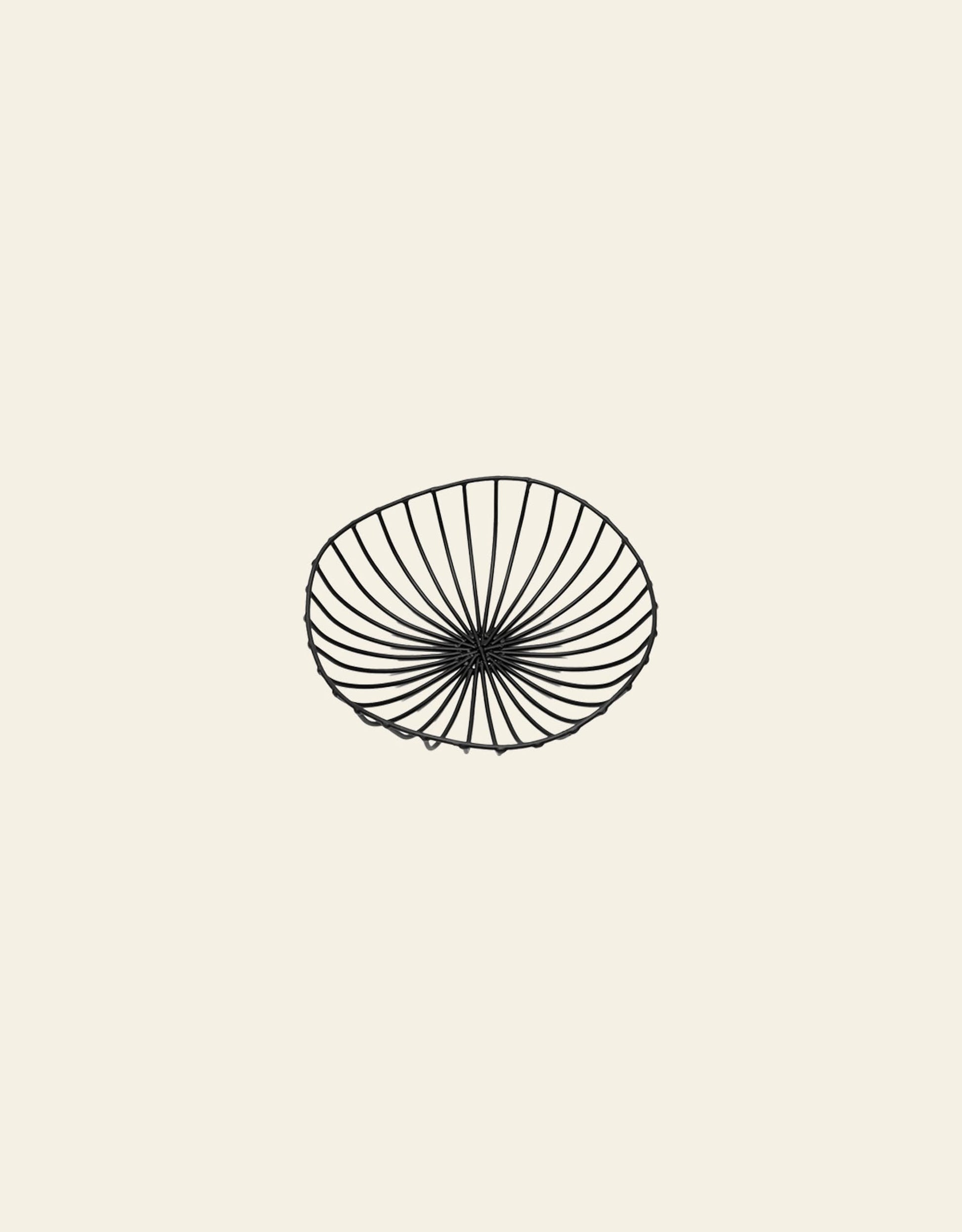 A simple black line drawing of the Serax Catu Bread Basket L by Serax, a shallow round metal basket with an open radiating pattern in Antonino Sciortinos style, centered on a light beige background.
