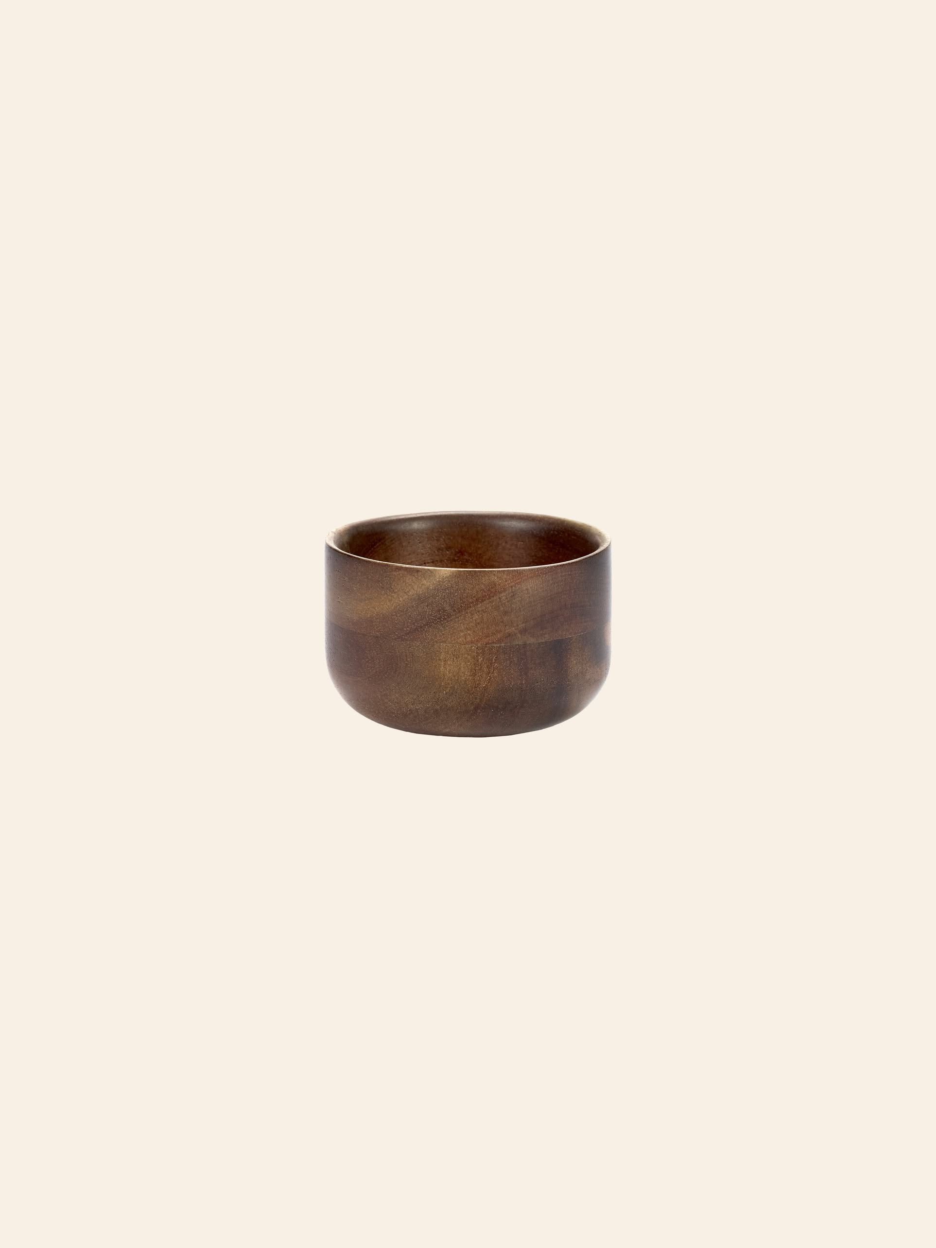 The Serax Collage Tea Cup in brown by Serax, featuring a smooth finish and round design, is showcased against a plain, light beige background.