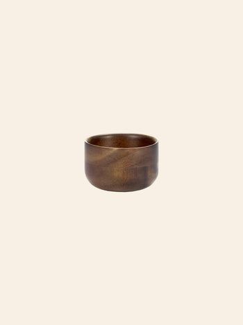 The Serax Collage Tea Cup in brown by Serax, featuring a smooth finish and round design, is showcased against a plain, light beige background.
