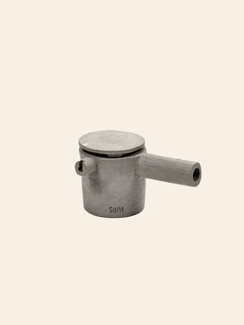 The Serax Fck Teapot N°3 - Grey Brown, by Serax, is a small, cylindrical metal teapot with a flat lid and short spout, highlighting Urbanistic Ceramics style against a plain beige background.