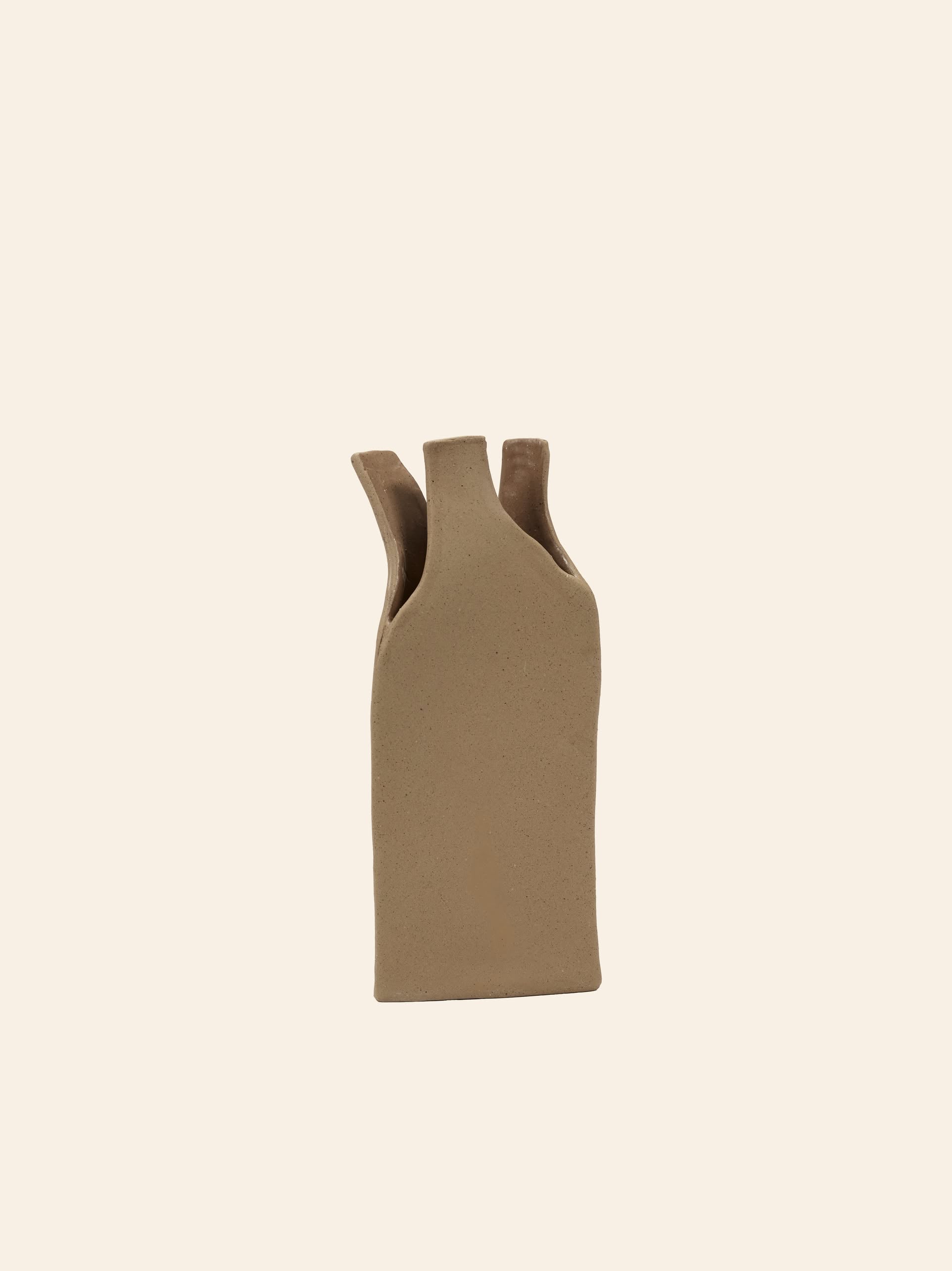 The Serax Flower Bottles Vase M in brown, by Serax, features a rectangular ceramic design with three narrow, uneven top openings—ideal for minimalist decor—displayed against a pale, off-white background.