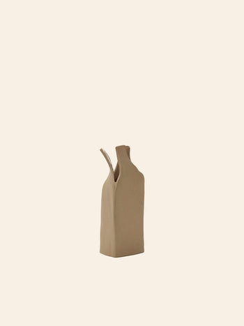 The Serax Flower Bottles Vase XS - Brown is a minimalist, ceramic vase with an abstract shape, crafted by Nadia Gallardo for Serax, featuring a narrow spout and a sleek design.
