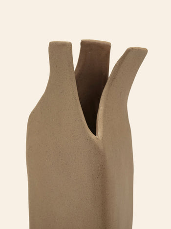 A close-up of the Serax Flower Bottles Vase XS - Brown, featuring sculptural, organically shaped openings in beige ceramic, designed by Nadia Gallardo for Serax, set against a light neutral background.