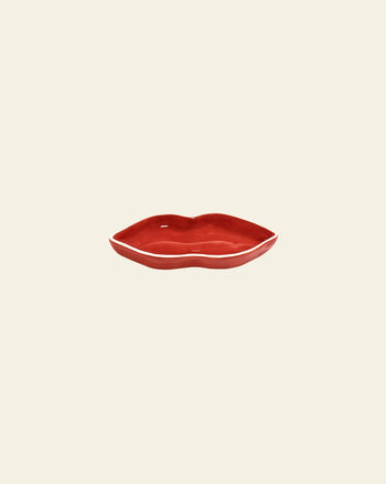 The Serax Les Objets Mouleversants Serving Dish S - Red, shaped like lips, is displayed centered on a plain beige background.