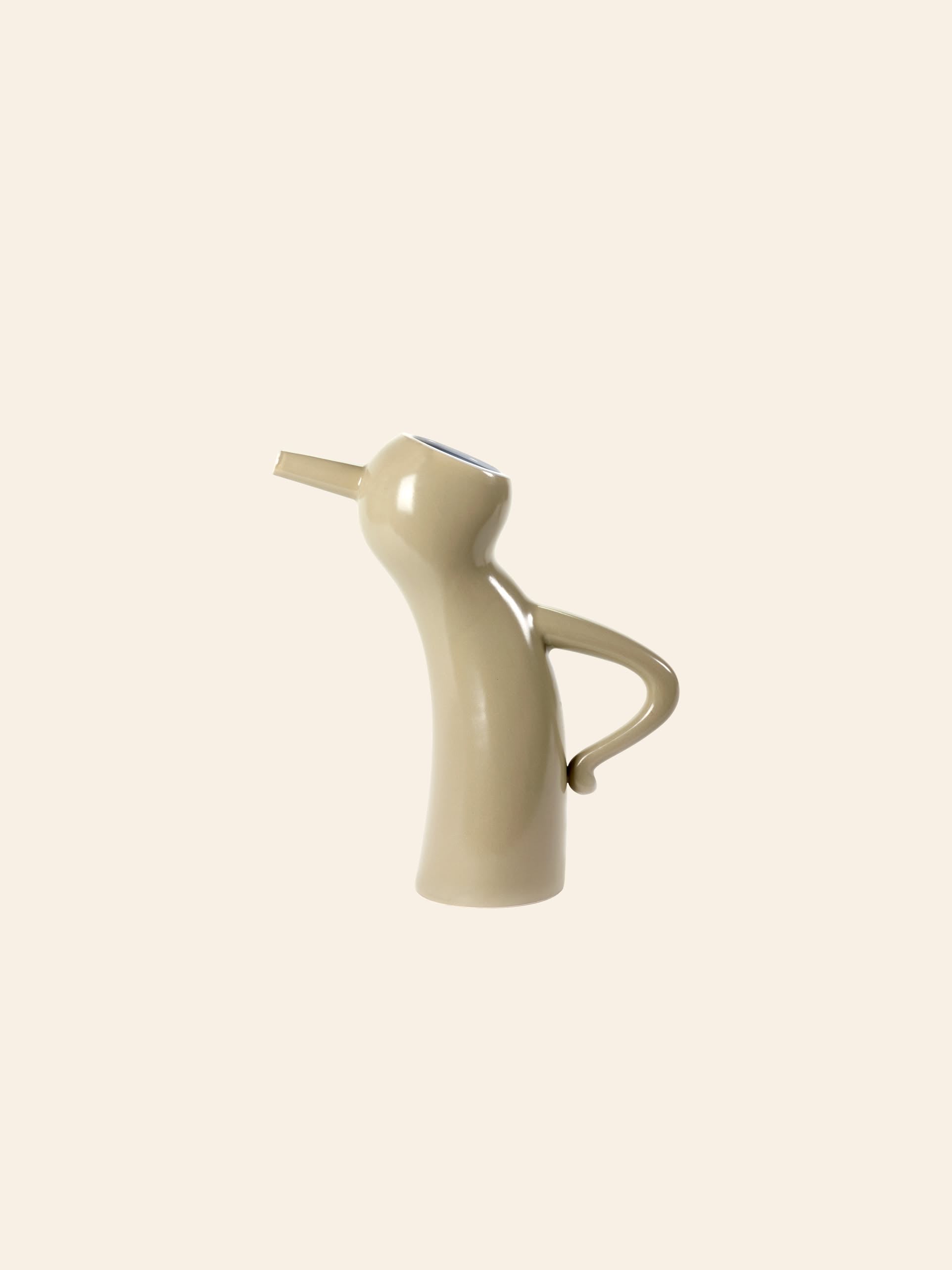 The Serax Monsieur Cruchot Jug L in taupe, by Serax, features a curved design and handle reminiscent of a whimsical watering can, making it a versatile decor piece for any space against a plain light background.