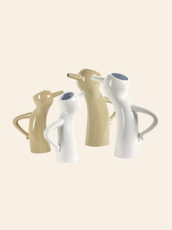 The Serax Monsieur Cruchot Jug L in taupe features a unique abstract human-like form with a curved handle and tilted spout, making it a versatile and stylish home decor accent.