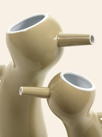 The Serax Monsieur Cruchot Jug L in taupe, by Serax, features a glossy ceramic finish and an abstract animal-shaped form, making it a versatile decor piece that stands out beautifully against light backgrounds.