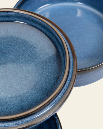 Set of three Serax Pure Stackable Bowl S in dark blue, featuring earthy glaze and brown rims. Handcrafted stoneware from the Serax Pure collection, shown close-up against a light beige background.