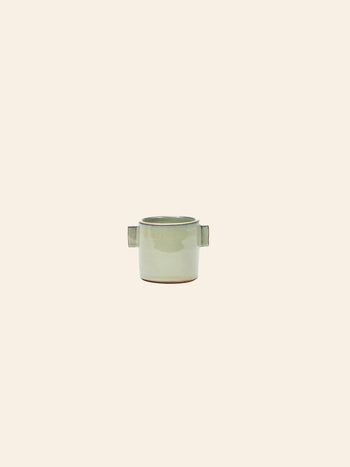 The Serax Urban Jungle Glazed Flower Pot S in grey by Serax features a waterproof coating, two rectangular side handles, and is displayed against a plain beige background.