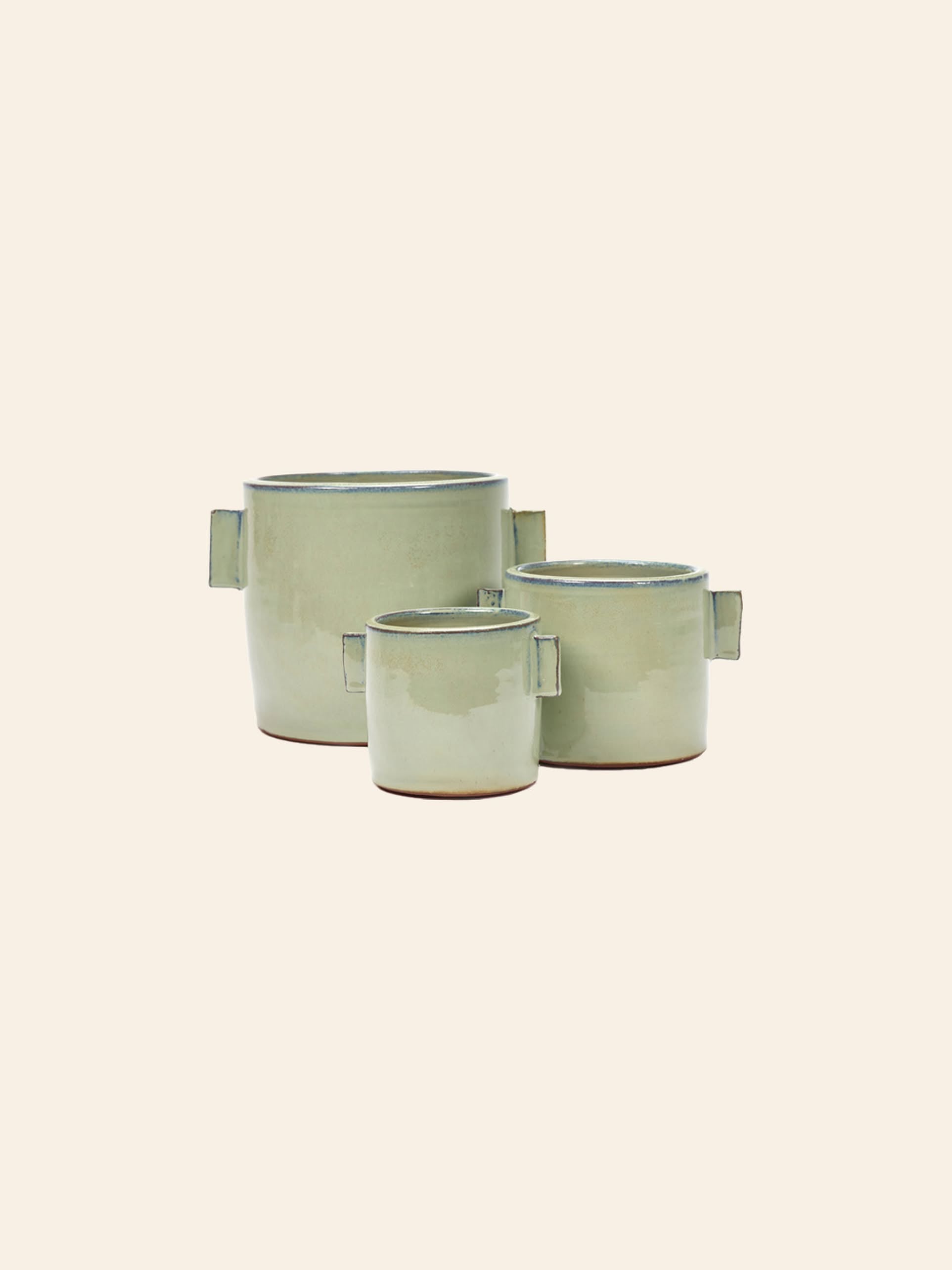 The Serax Urban Jungle Glazed Flower Pot S in grey by Serax features a waterproof coating and square side handles—perfect for adding a fresh, modern touch to your indoor space.