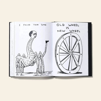An open Shrig Shop David Shrigley - I Am The Jug You Are The Glass book by Shrig Shop displays a surreal human-headed spider with a shoe on one page, and a wagon wheel illustration with the text “OLD WHEEL IS NEW WHEEL” on the other.