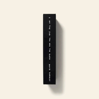 Shrig Shops limited edition David Shrigley - I Am The Jug You Are The Glass book features a black spine with white text and is set against a plain light beige background.