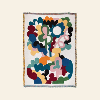 The Slowdown Studio Alessi Throw features an abstract design of colorful, interconnected organic shapes on a cream background with multicolored fringe, crafted from recycled cotton for a sustainable touch.