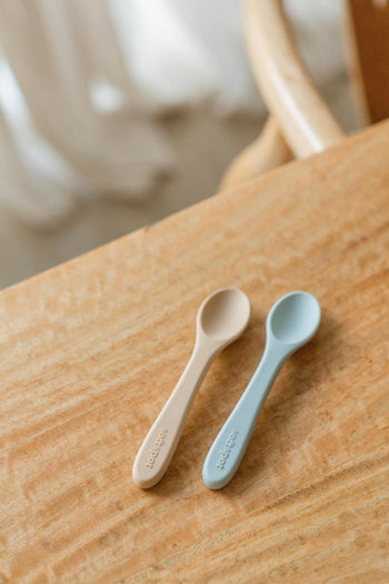 The Soft Spot Soft Baby Spoons, Set of 2 by Soft Spot, includes one beige and one light blue spoon—perfect for babys first bites, gentle on teething gums, and easy to use at feeding time.