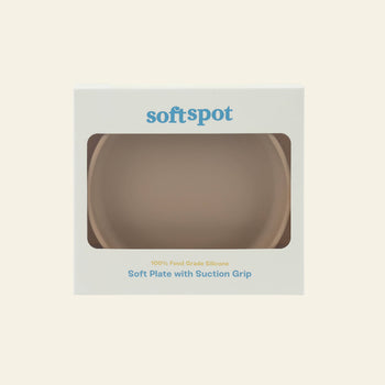A beige Soft Spot Soft Suction Plate in partially transparent packaging labeled Soft Spot is shown. The box highlights a strong suction grip and reads 100% food-grade silicone and Soft Suction Plate in blue text.