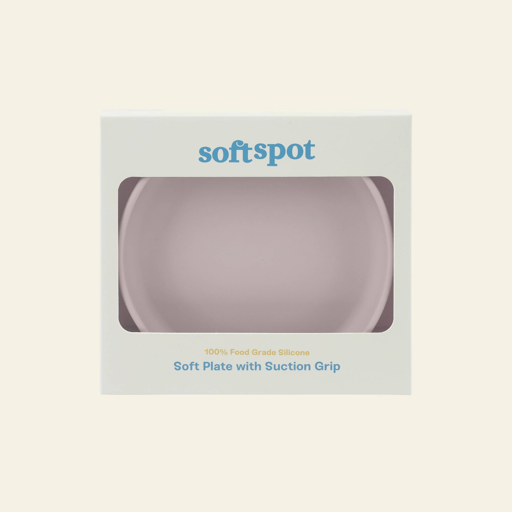 A boxed Soft Spot Soft Suction Plate by Soft Spot, made of food-grade silicone with a strong suction grip, visible through a front clear window. The light-colored box features blue and gray text for safe and fun mealtimes.