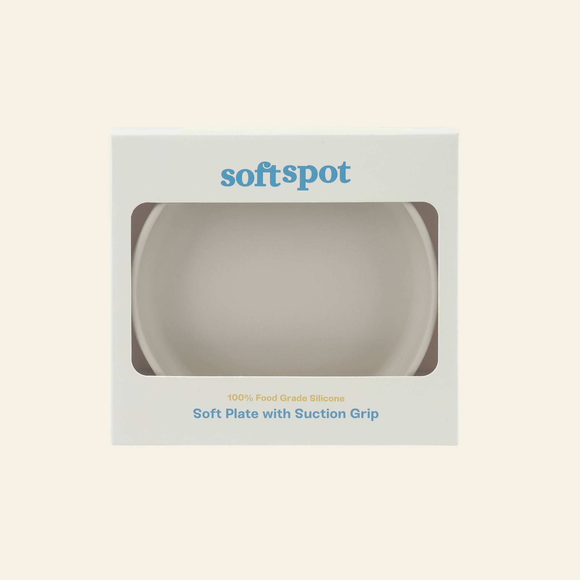 The Soft Spot Soft Suction Plate by Soft Spot is a white, food-grade silicone plate in softspot packaging. The box has a cut-out window showing the plate inside and highlights its strong suction for secure, mess-free meals.