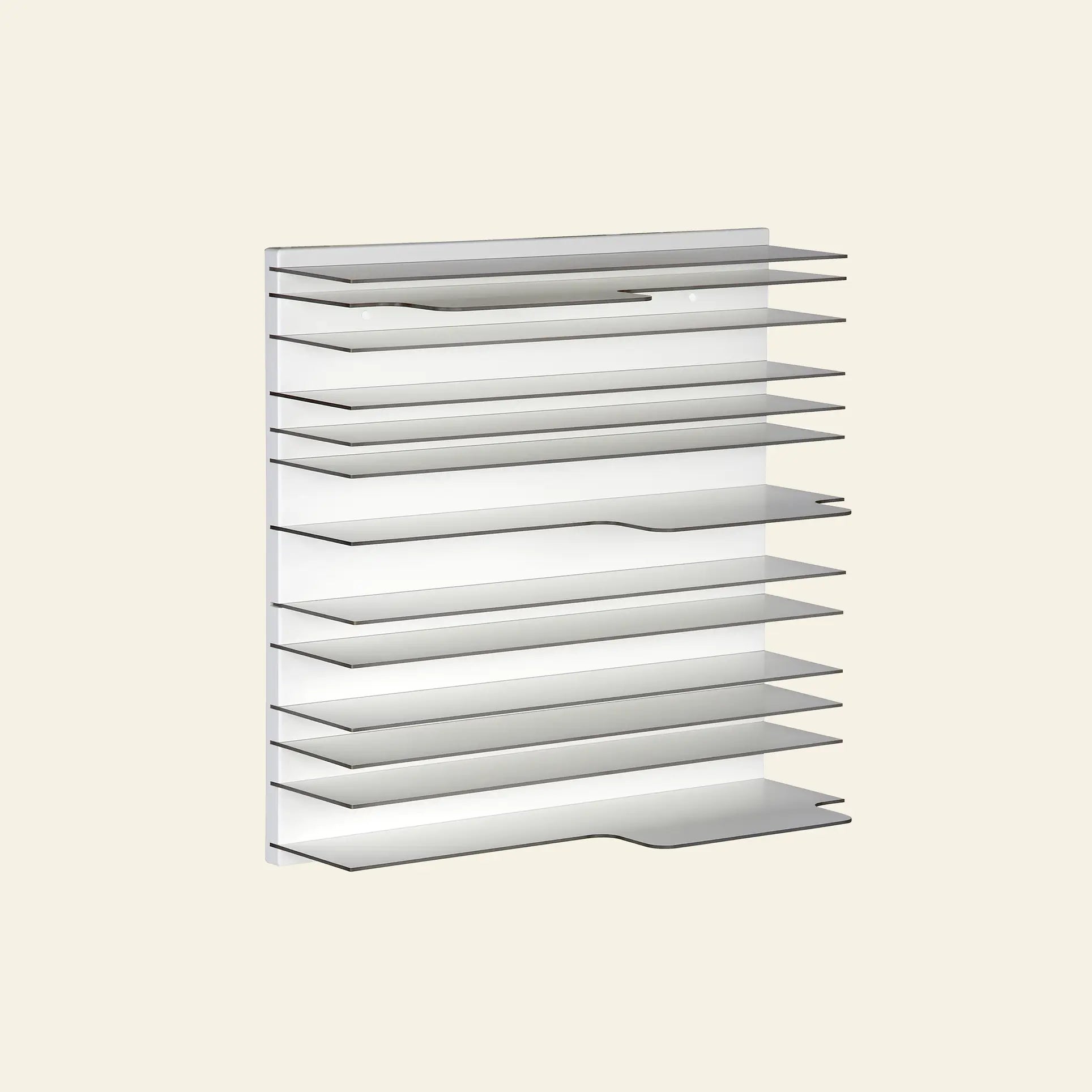 The Spectrum Paperback Wallsystem 60x60 by Spectrum is a modern, minimalist wall-mounted shelf unit with a modular design. It features multiple thin, evenly spaced horizontal shelves against a plain light background, crafted from durable materials.