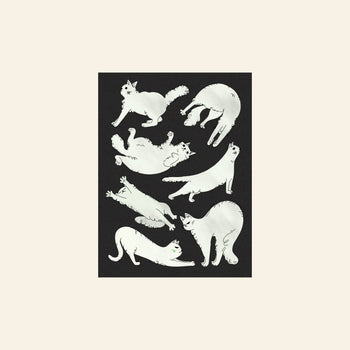 Stacked Store’s Jaeyyelle Cat Poster (30x40) features seven white cats in playful poses on black, framed in light beige—a whimsical collectible art piece perfect for cat lovers.