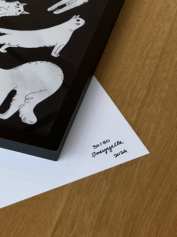 A close-up of the Stacked Store Jaeyyelle - Cat Poster (30x40), a whimsical cat-themed framed illustration. This exclusive signed and numbered print (30/50) from Stacked Store features the artist’s signature and 2024 in the corner.