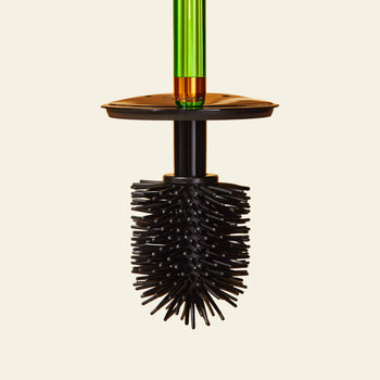 The Staff The Toilet Brush - Green by Staff, with a black silicone brush and flexible bristles, a green acrylic handle, and a replaceable head, is displayed upright against a plain beige background.