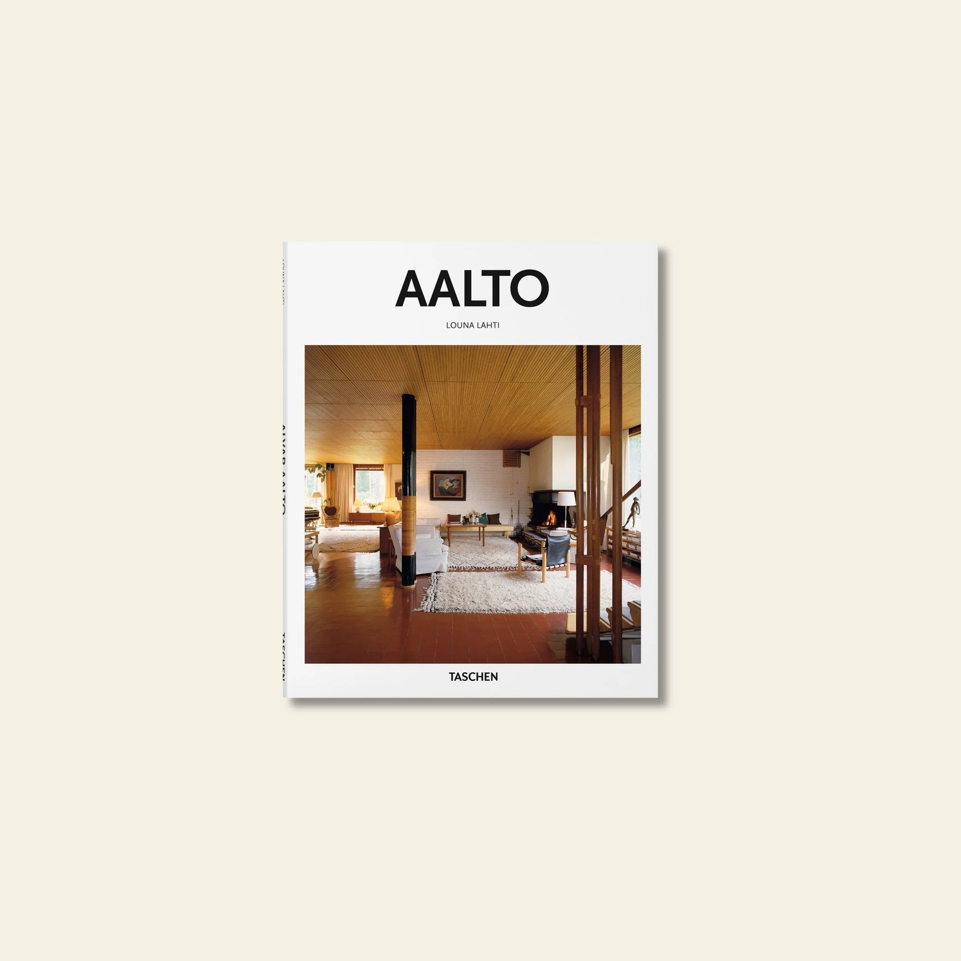 The TASCHEN Aalto book cover features an interior photo of a modern living room inspired by architect Alvar Aalto, with wooden ceilings, white walls, minimalist furniture, a fireplace, and the TASCHEN brand mark at the bottom.