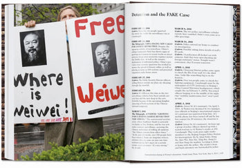A person holds two protest signs with Ai Weiwei’s portrait and slogans, shown beside a page from TASCHEN Ai Weiwei, the renowned monograph by TASCHEN.