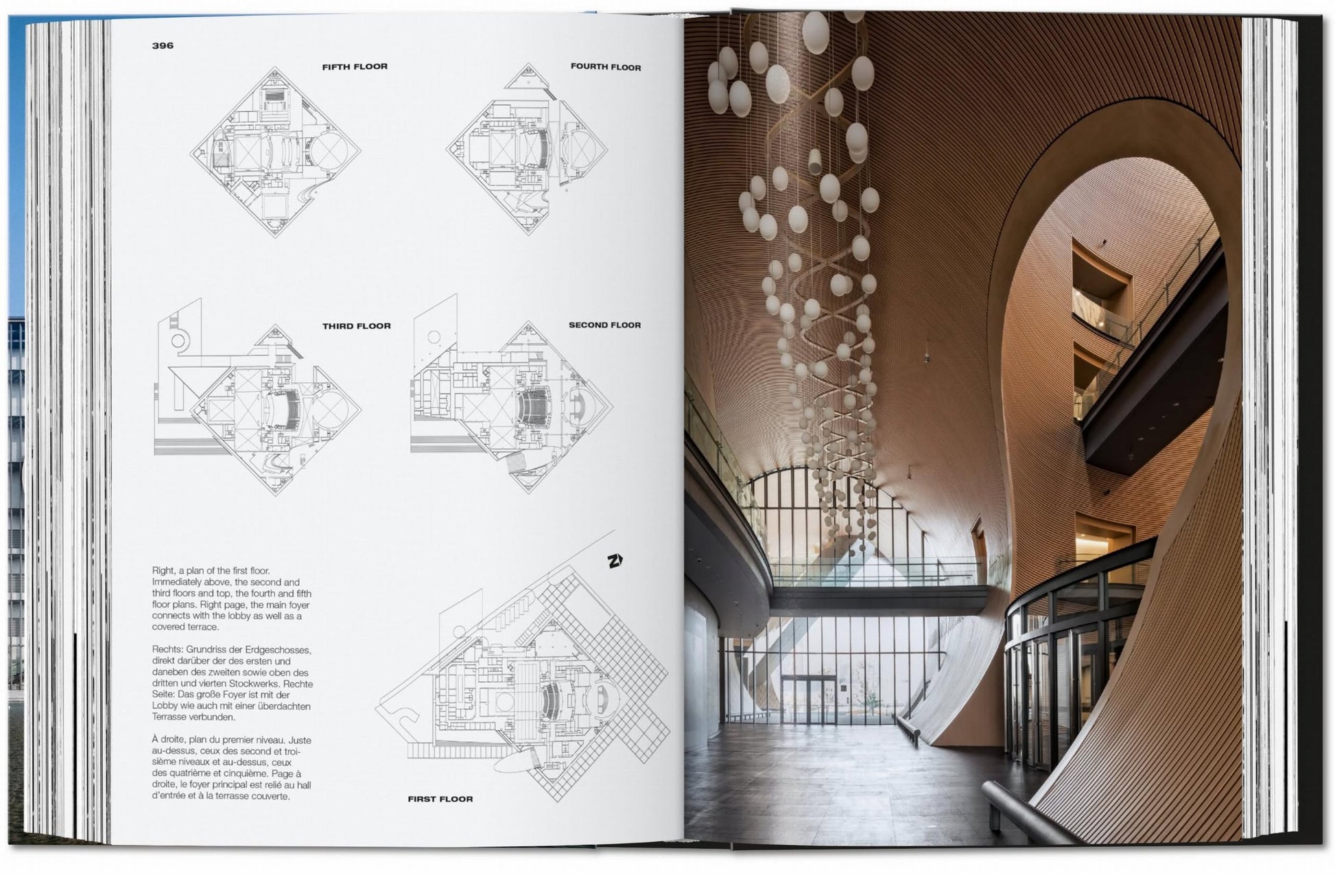 TASCHEN Ando: Complete Works 1975-Today—an open book reveals detailed floor plans alongside a modern interior with curved wooden walls and hanging lights, exemplifying elegant minimalist architecture.