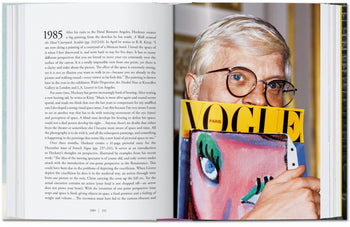 An open copy of TASCHEN David Hockney: A Chronology displays a photo of a short blond-haired person with glasses holding a Vogue Paris magazine, its colorful painted-face cover partially hiding their face, while text fills the left page.