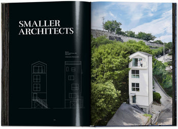 An open TASCHEN Homes for Our Time: Small Houses (XL) book shows text on the left and a photo of a slim, modern white house—highlighting petite architecture and sustainable living—surrounded by greenery and urban scenery on the right.